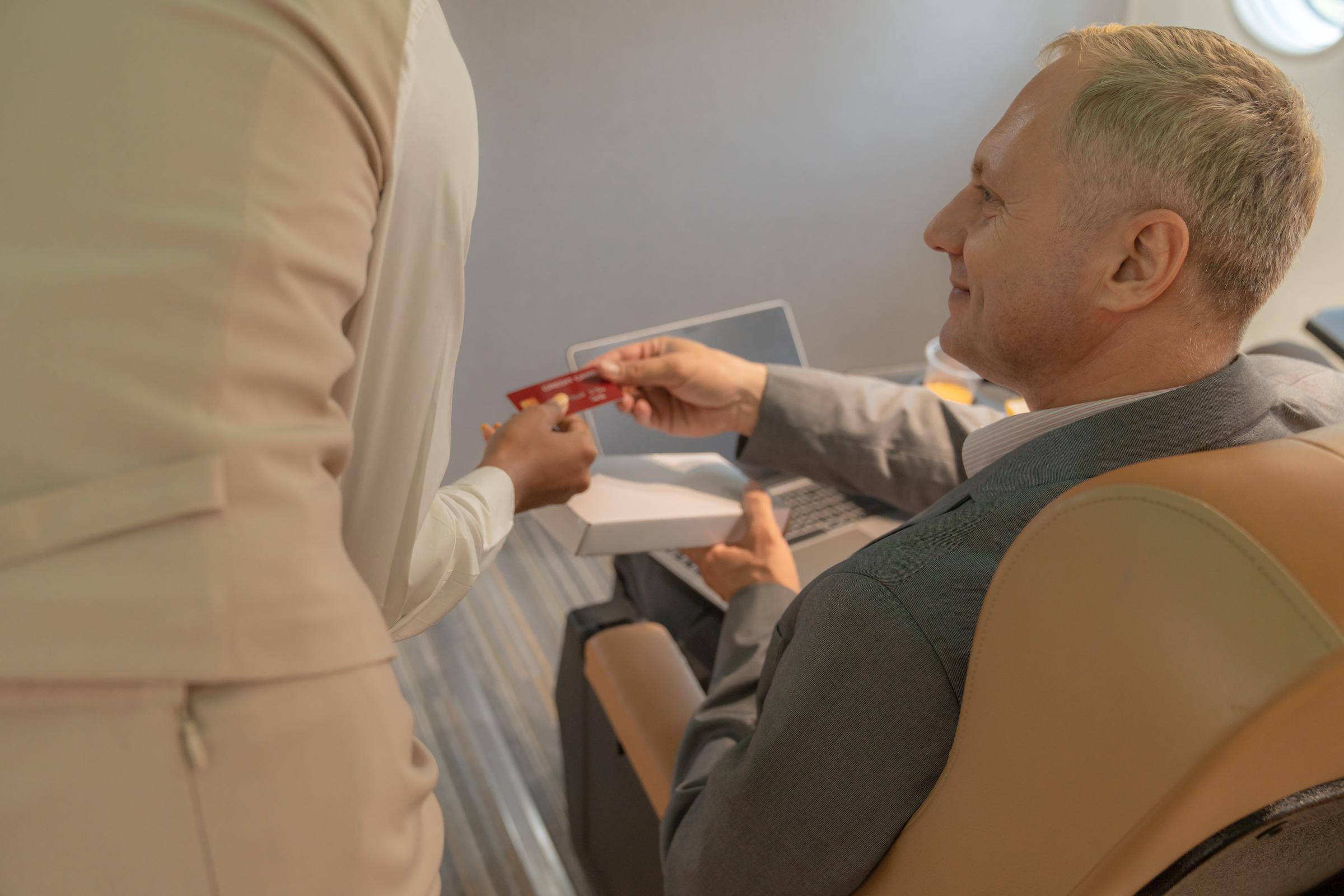 Businessman talking to a flight attendant | Source: Shutterstock