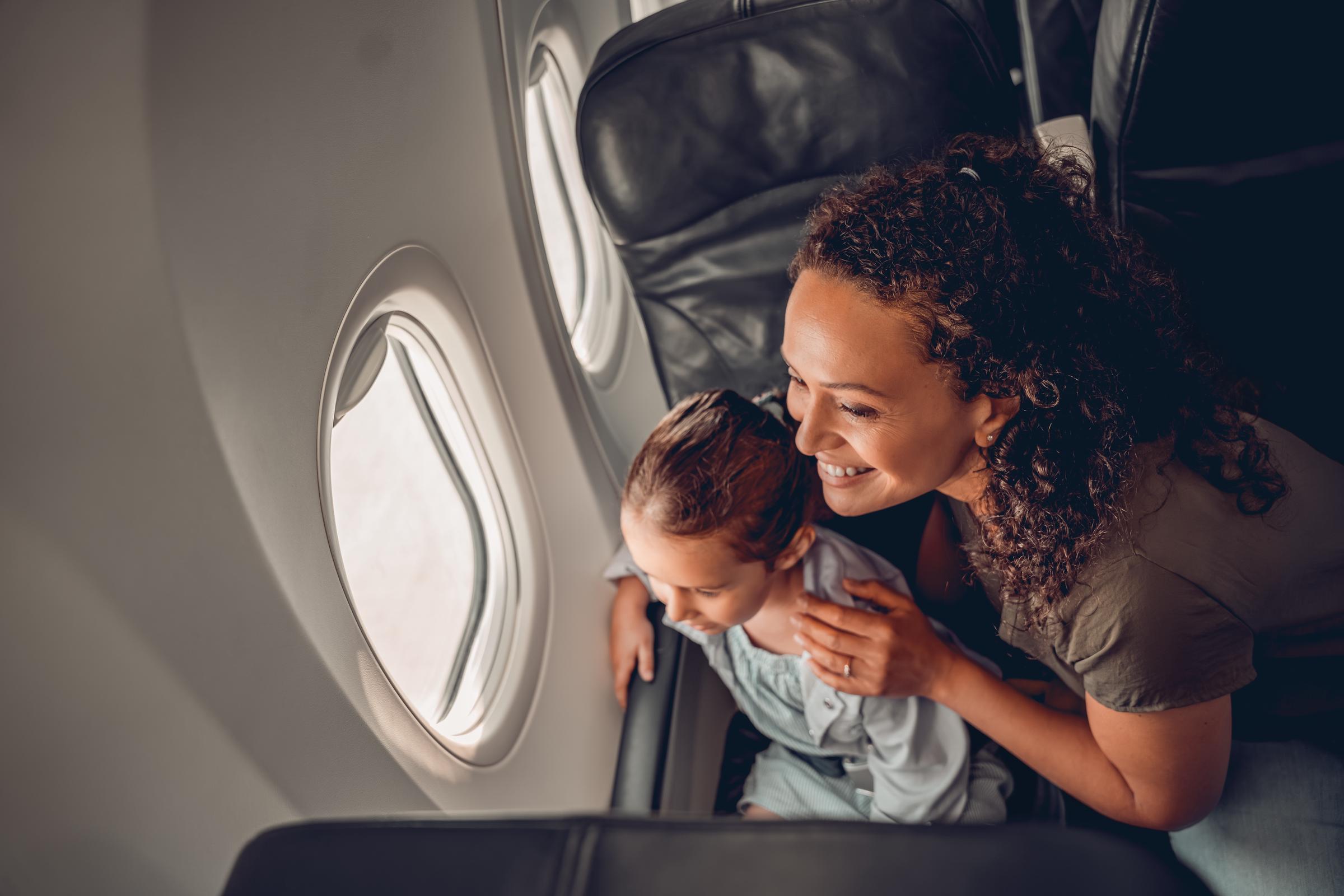 Mother and son inside a plane | Source: Shutterstock