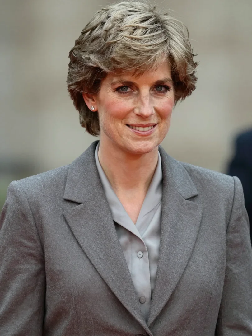 In this AI-generated image, Princess Diana is imagined as a woman of 64, her familiar features softened by time but still instantly recognisable. Dressed in a structured grey blazer and blouse, she appears composed and dignified — a vision of the modern royal she may have become, had history allowed. | Source: Grok