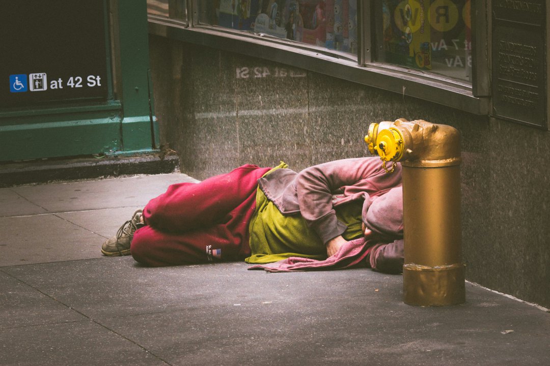 A homeless person sleeping on the floor | Source: Unsplash