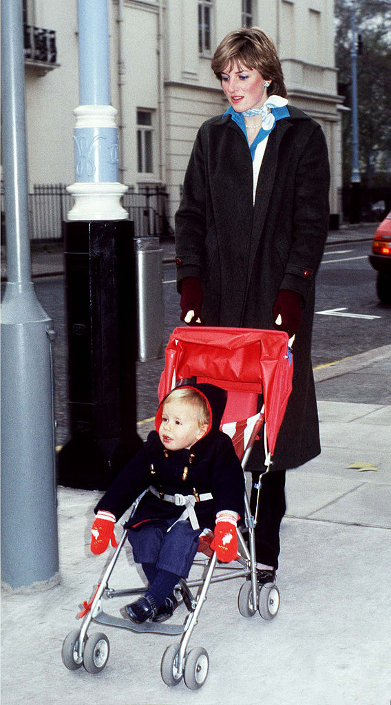 Before royal life beckoned, Princess Diana, then Lady Diana Spencer, was already devoted to caring for others. Pictured here in November 1980, she pushes toddler Patrick Robinson through London's Eaton Square district during her time as a nanny. Wrapped in a long coat and deep red gloves, the royal cuts a quietly elegant figure.