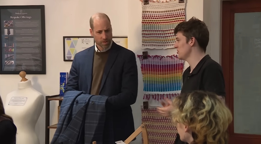 Holding his wife's blue tartan coat in his arms, Prince William spoke with a member of the Radical Weavers team about the organisation's work. The setting, filled with vibrant handwoven textiles, reflected the spirit of the charity's mission to celebrate Scottish heritage through inclusive, creative community outreach. | Source: YouTube/The Royal Family Channel