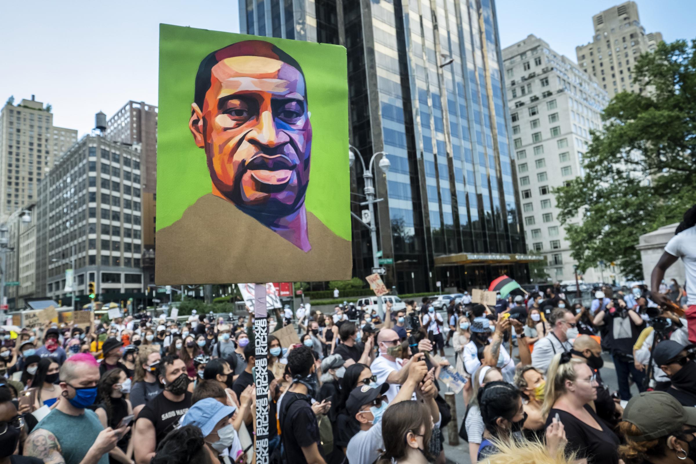 Protesters hold a portrait of George Floyd during a demonstration against police violence and racial injustice on June 14, 2020 | Source: Getty Images