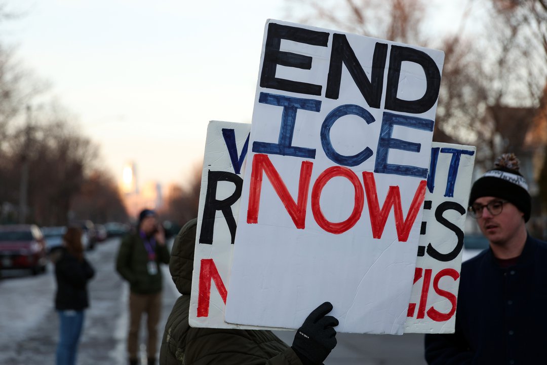 A demonstrator holds a sign during a vigil following a shooting by an ICE agent during federal law enforcement operations in Minneapolis, Minnesota  on January 7, 2026. | Source: Getty Images