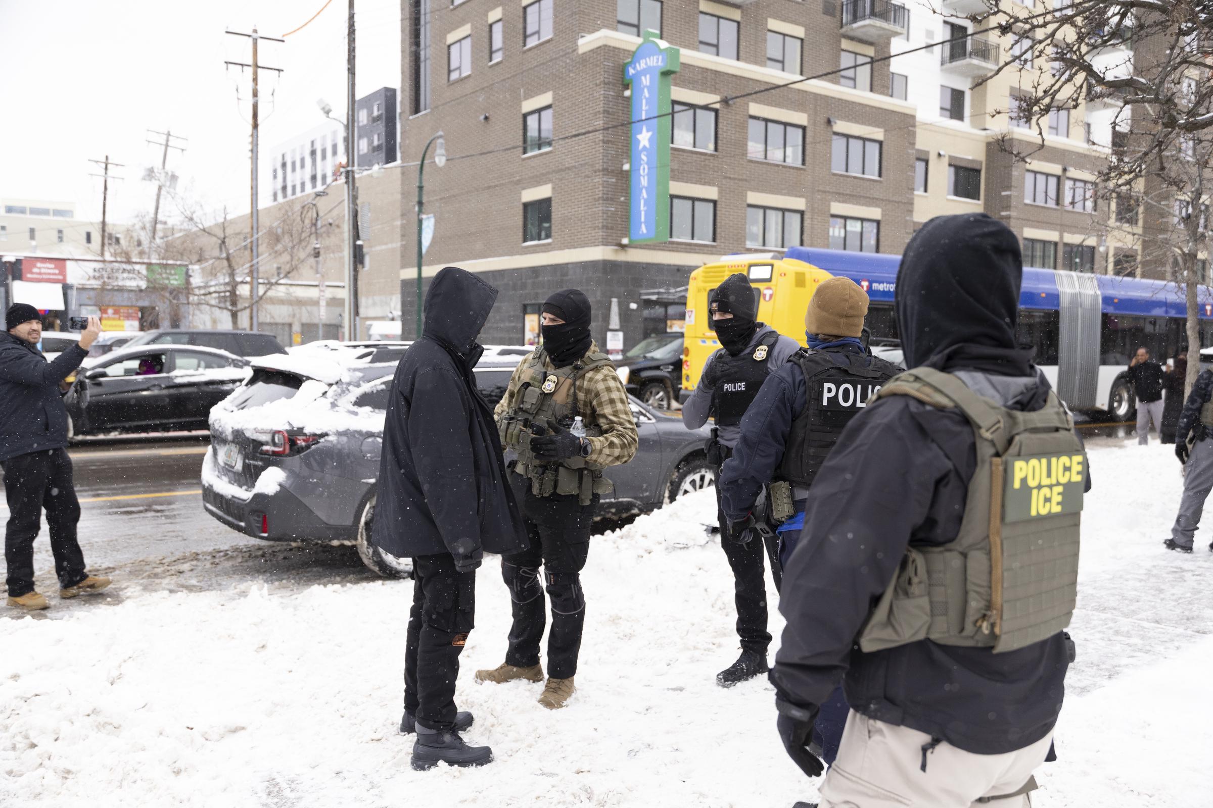 Immigrations, Customs, and Enforcement officers standing on a street. | Source: Getty Images