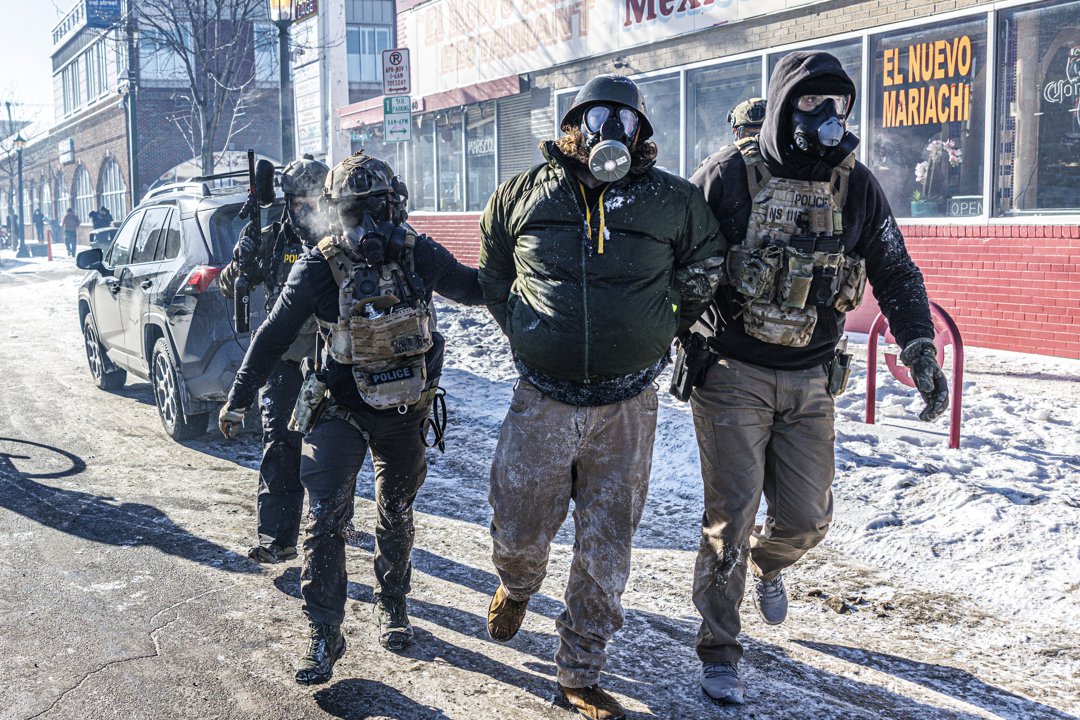 Federal agents detain a protester along a commercial street in Minneapolis, Minnesota on January 24, 2026. | Source: Getty Images
