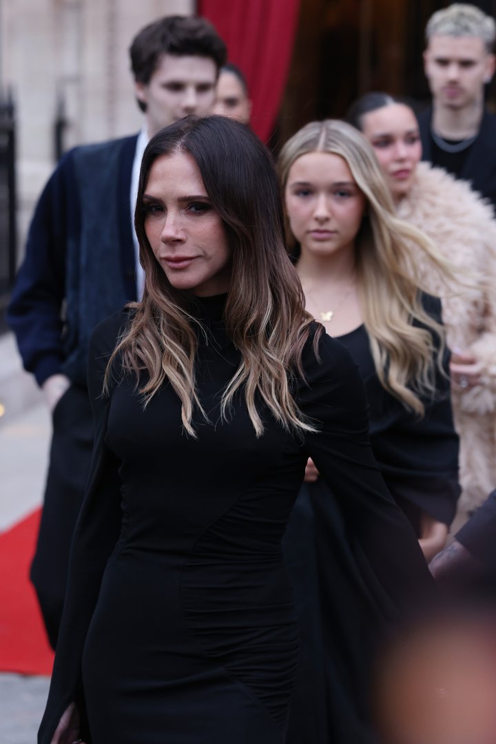 Victoria is photographed close up, clad in a sleek black dress. Flanked by her children and husband David, the designer looked focused and steely on a day meant to celebrate her legacy &mdash; but shadowed by private heartbreak.