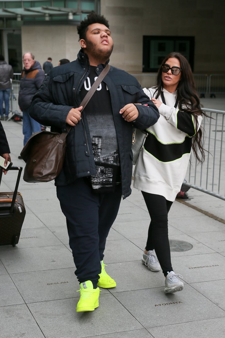 Harvey Price walks confidently ahead of his mother, Katie Price, as they leave the BBC TV studios in London on February 6, 2019. Wearing eye-catching neon trainers and carrying a satchel, Harvey had just taken part in another media appearance alongside Katie, who at the time was pushing for stronger legislation against online abuse with the proposed Harvey's Law.