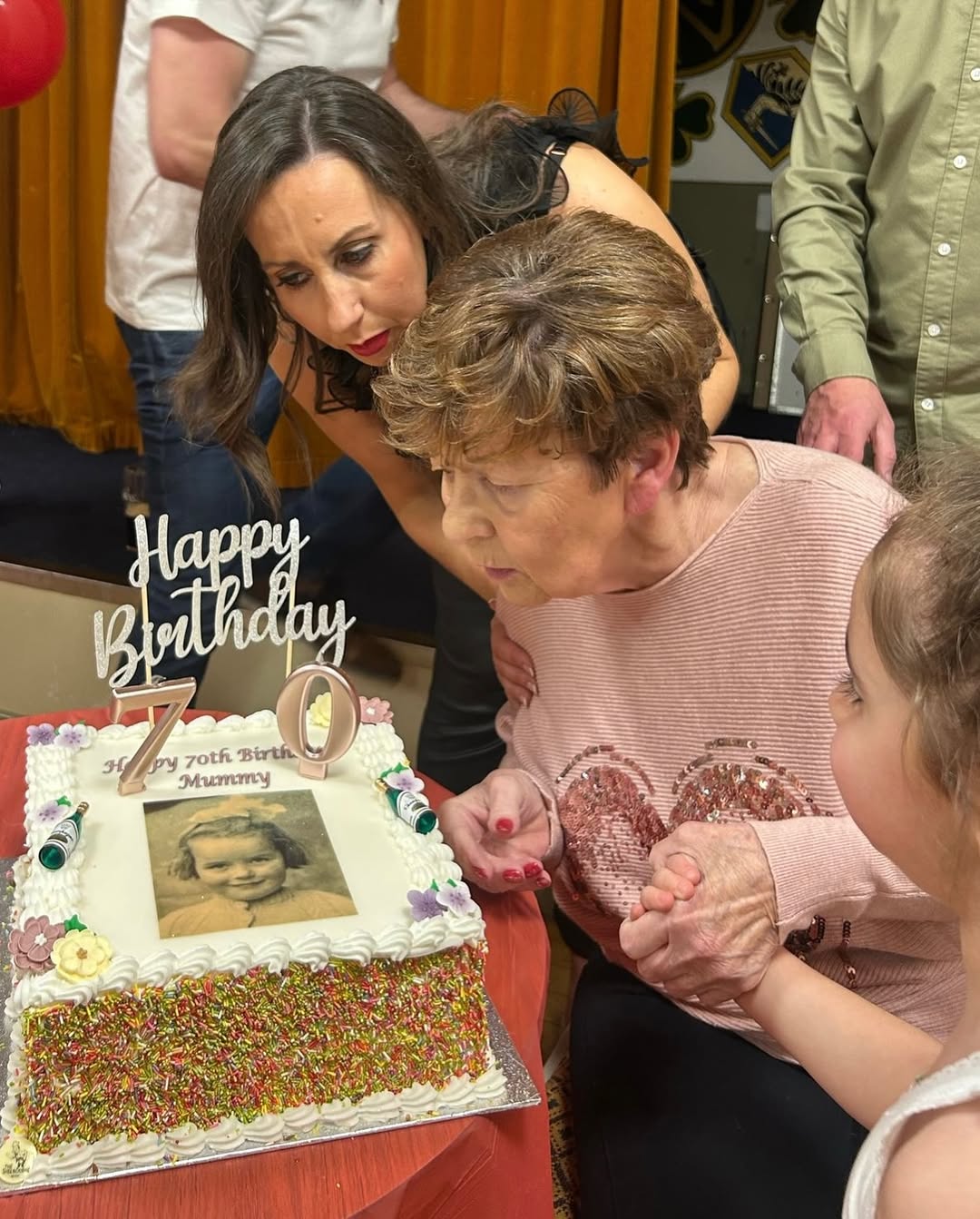 Rachel Duffy's mother Anne (C) is pictured with blowing the candles on her birthday cake, in a photo shared on 14 March 2025. | Source: Instagram/rachel.duffy