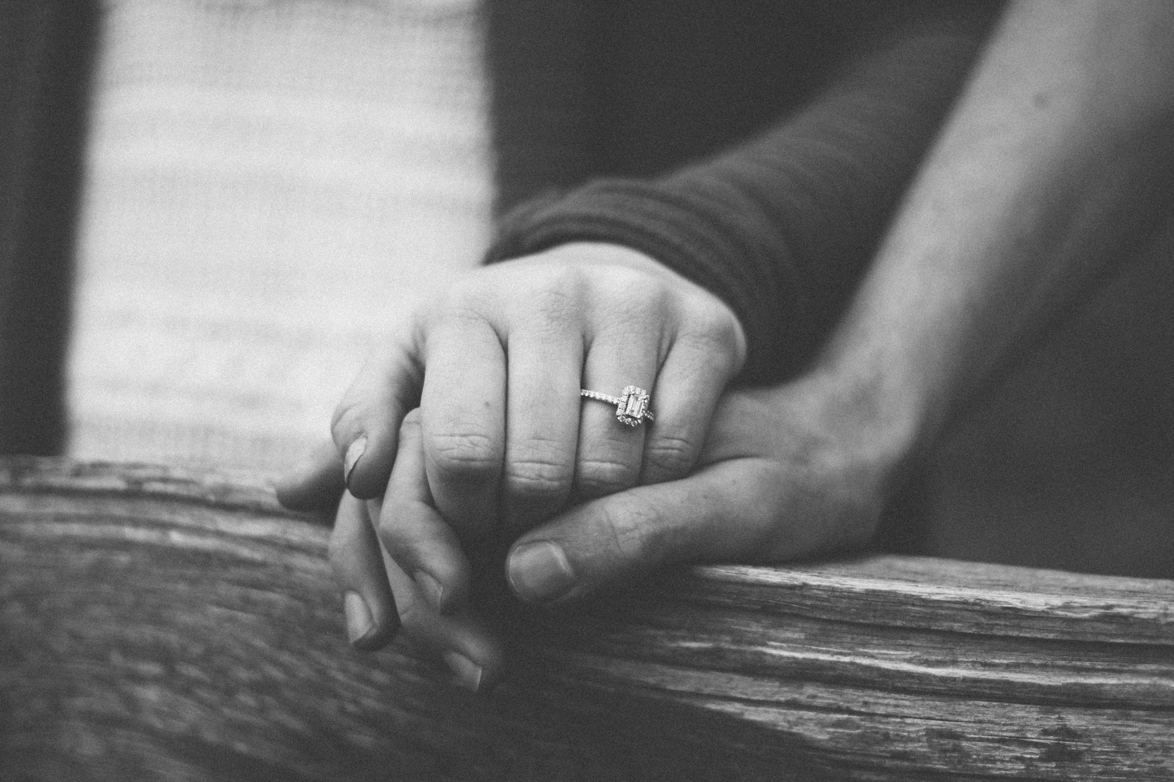 A grayscale photo of a couple holding hands | Source: Unsplash