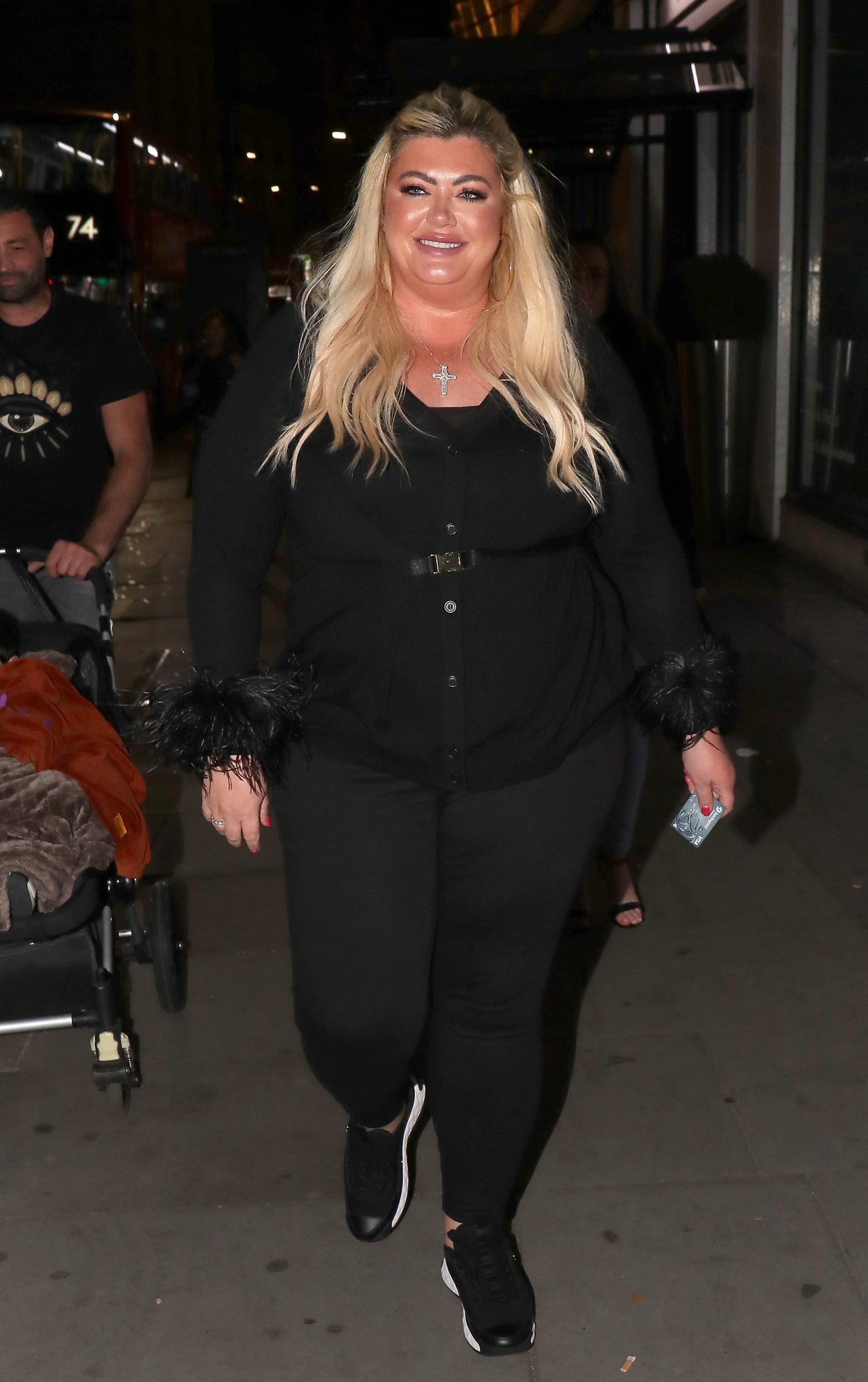 Gemma Collins was seen leaving Nusr Et restaurant in London on September 23, 2021, dressed in an all-black ensemble featuring feather-trimmed sleeves and a belted waist. Pairing the look with sleek trainers and her signature glam makeup, she appeared upbeat and radiant during a night out, continuing to embrace fashion-forward choices while stepping out in confidence.