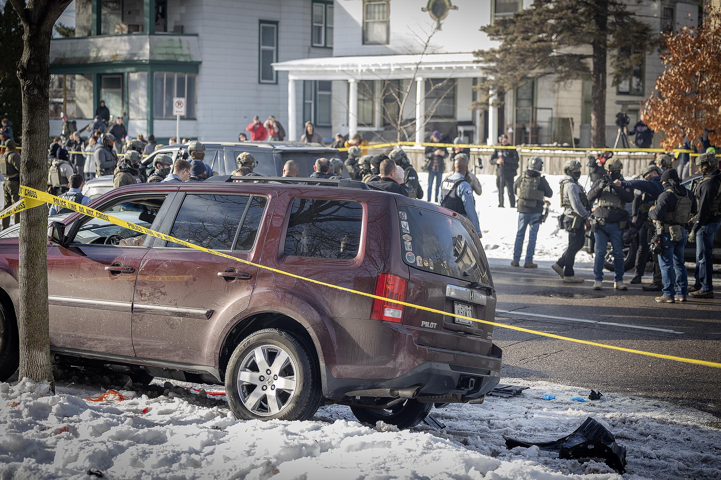 Scene of an ICE-involved shooting in south Minneapolis on January 7, 2026, where a burgundy SUV with a bullet hole in the windshield is surrounded by agents | Source: Getty Images