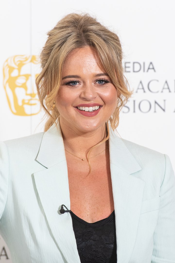 Emily Atack attended the Virgin Media BAFTA TV Awards in London on July 31, 2020. Wearing a powder blue blazer over a black lace top, she appeared with a fuller, rounded face and a radiant complexion. Her softly swept-up hair and glowing smile captured a moment of polished confidence during a period when her appearance continued to draw both admiration and media attention.