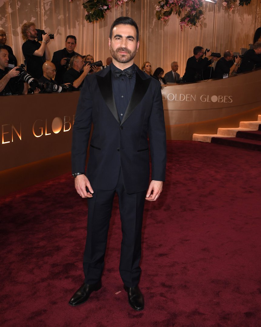Brett Goldstein Keeps It Classic with Polished Charm: Brett Goldstein cut a dashing figure at the 83rd Annual Golden Globe Awards, stepping out in a timeless black tuxedo. With effortless style and signature ease, the actor and writer delivered red carpet elegance with a modern edge.