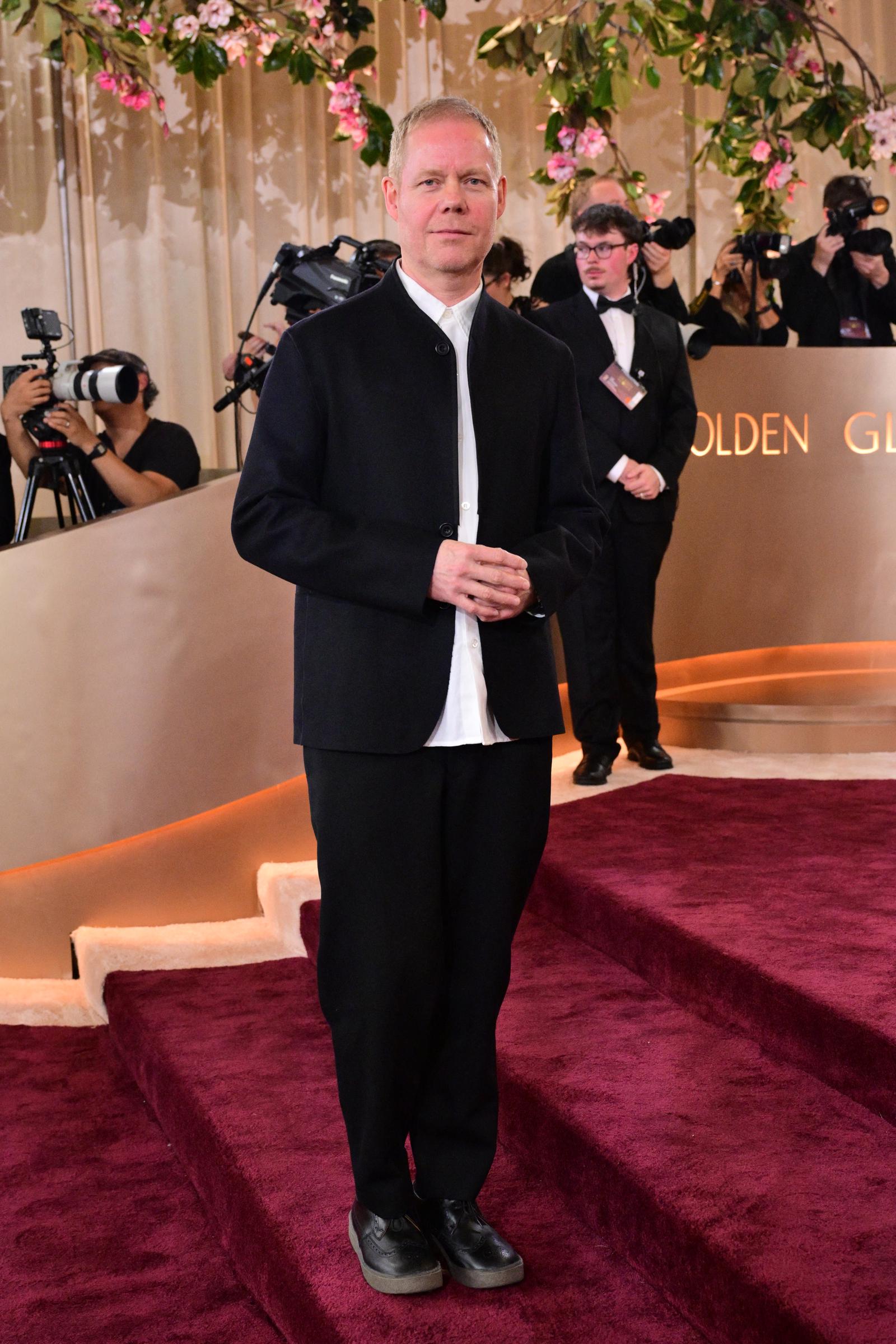 Max Richter Keeps It Minimalist and Sophisticated: Acclaimed composer Max Richter stepped onto the red carpet with refined simplicity, layering a black jacket over a crisp white shirt. His understated look reflected a quiet confidence as he arrived at the industry's most prestigious celebration.