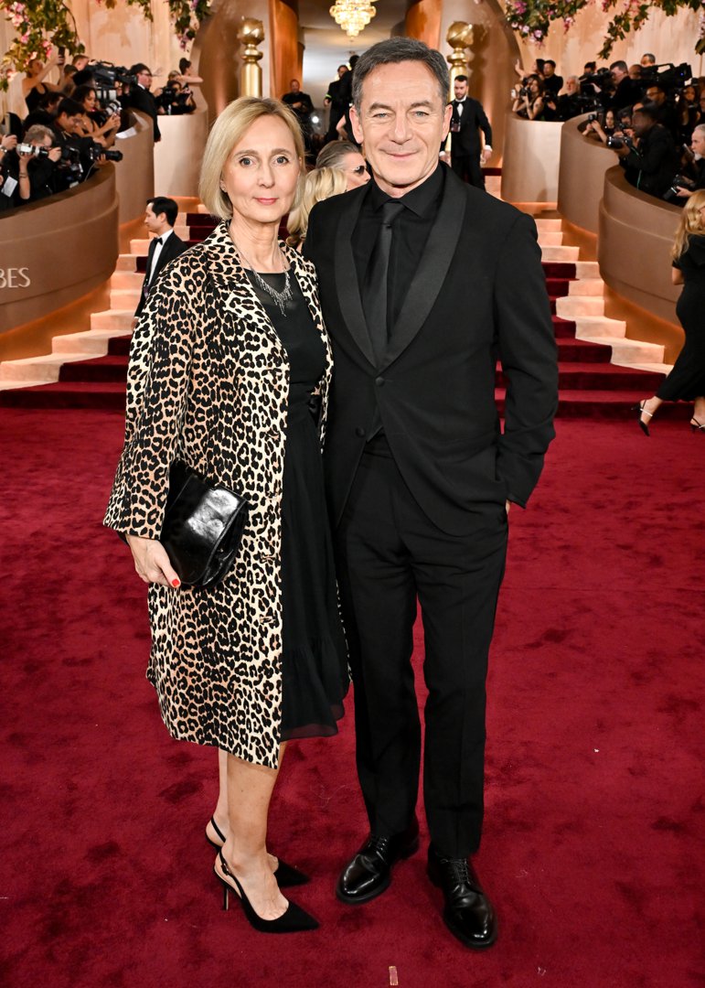 Jason Isaacs and Emma Hewitt Share a Glamorous Arrival: Jason Isaacs and wife Emma Hewitt made a picture-perfect entrance at the 83rd Annual Golden Globes, posing hand in hand in coordinated eveningwear. Their shared smile and subtle style spoke volumes &mdash; a red carpet moment filled with warmth and polish.