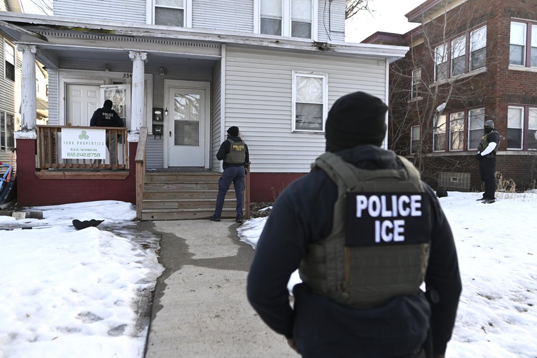 ICE agents approach a home during an immigration enforcement operation in Minneapolis, Minnesota, on January 13, 2026 | Source: Getty Images
