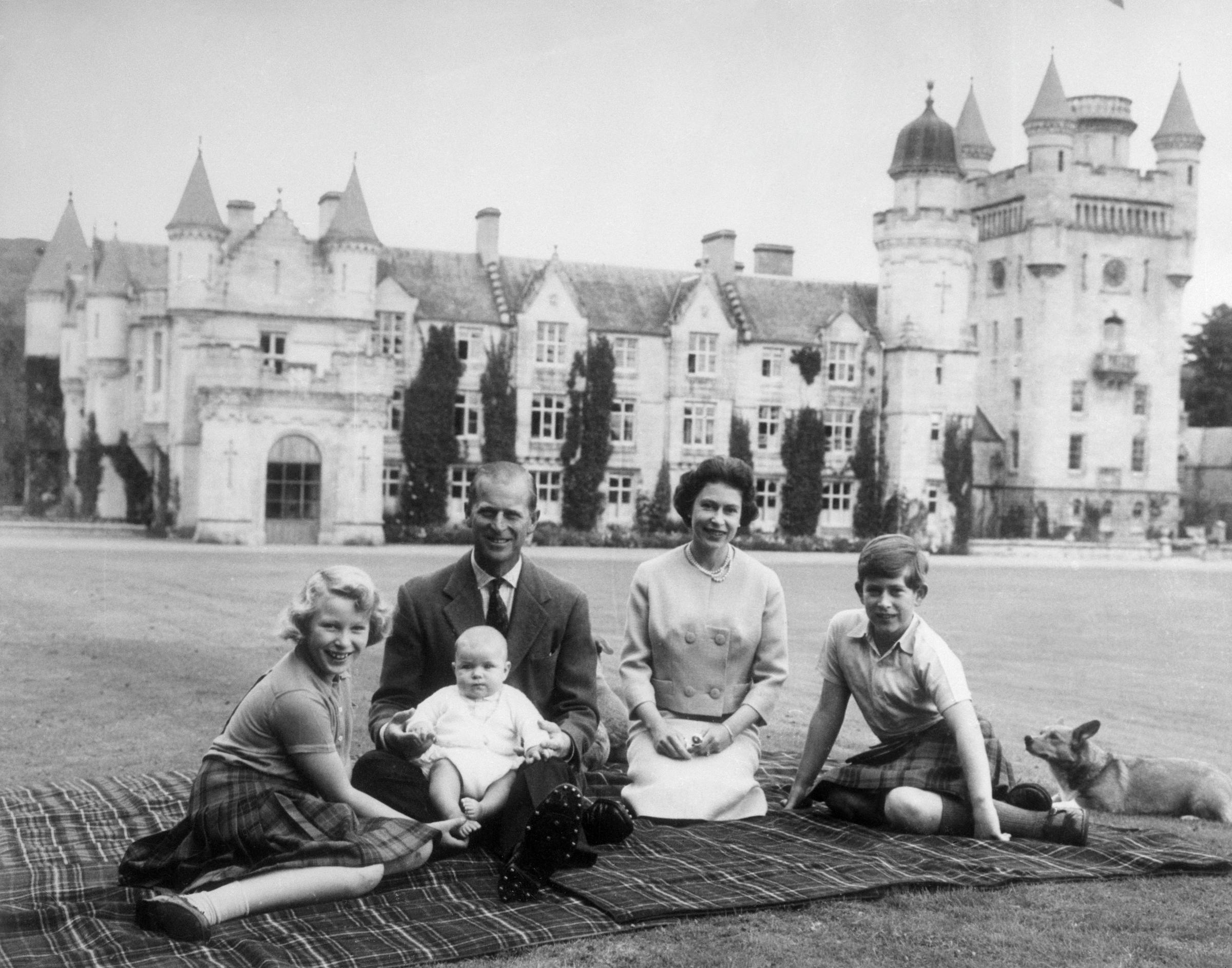 Queen Elizabeth II and Prince Philip, Duke of Edinburgh, with their children, Andrew Mountbatten-Windsor, Princess Anne, and then Prince Charles photographed outside Balmoral Castle in Scotland on September 8, 1960. | Source: Getty Images