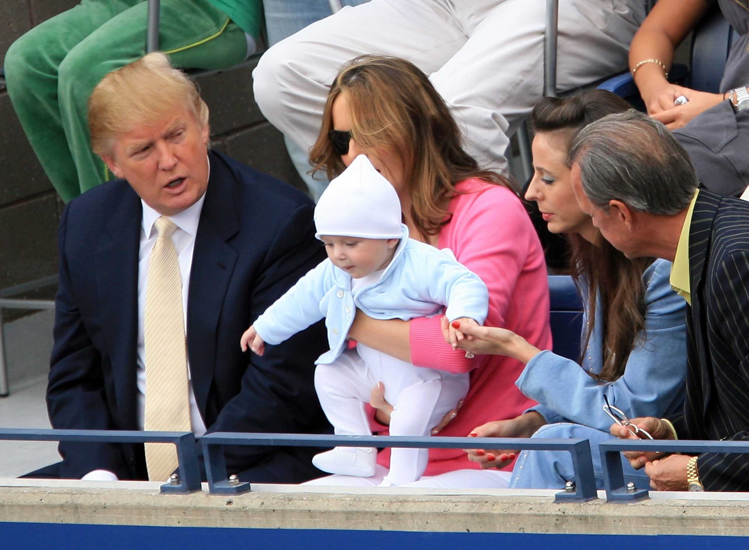 Courtside at the U.S. Open, Melania Trump holds baby Barron as Donald Trump looks on during the men&rsquo;s final between Roger Federer and Andy Roddick.