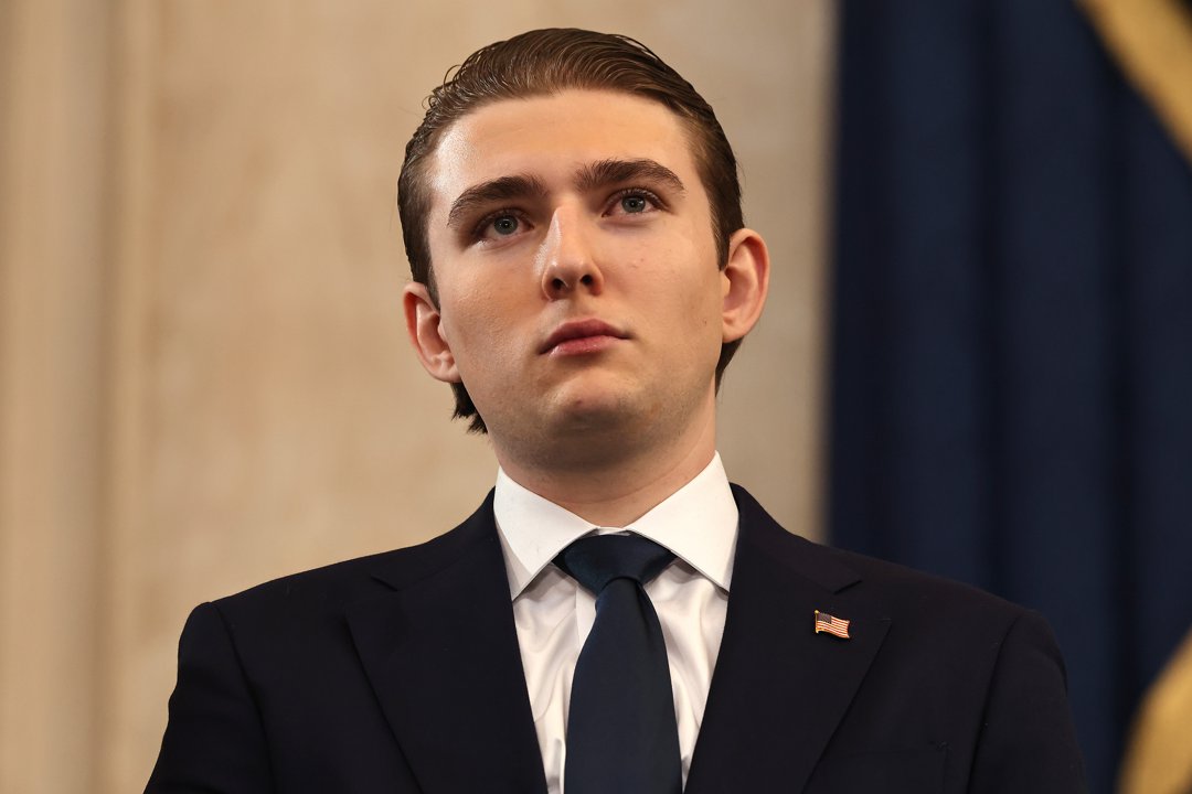Standing in the Rotunda of the U.S. Capitol, Barron Trump appears in a dark suit and tie, an American flag pin fixed to his lapel, his gaze lifted as he attends the inauguration marking Donald Trump&rsquo;s swearing-in as the 47th president of the United States.