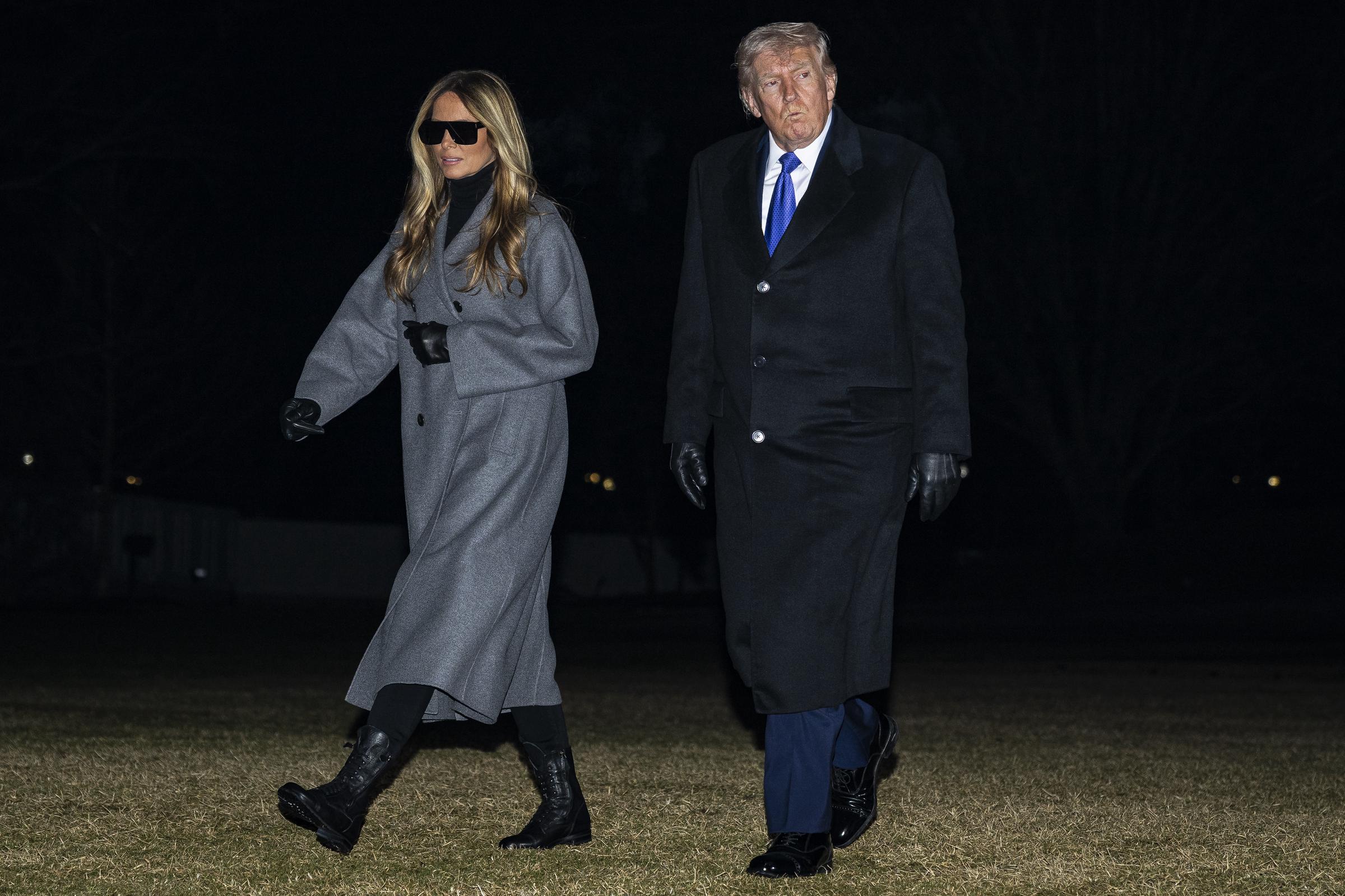Donald Trump and Melania Trump walk on the South Lawn after returning to the White House on February 16, 2026, in Washington, DC | Source: Getty Images