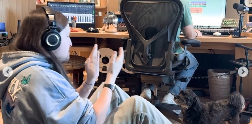 Max Martin plays with a dog while working on 