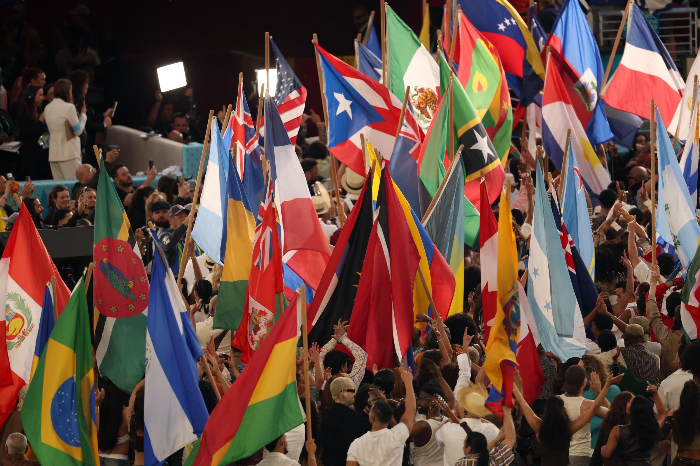 Performers wave the flags of sovereign countries in the Americas at the conclusion of the Apple Music Super Bowl LX Halftime Show, marking the finale of Bad Bunny's set.