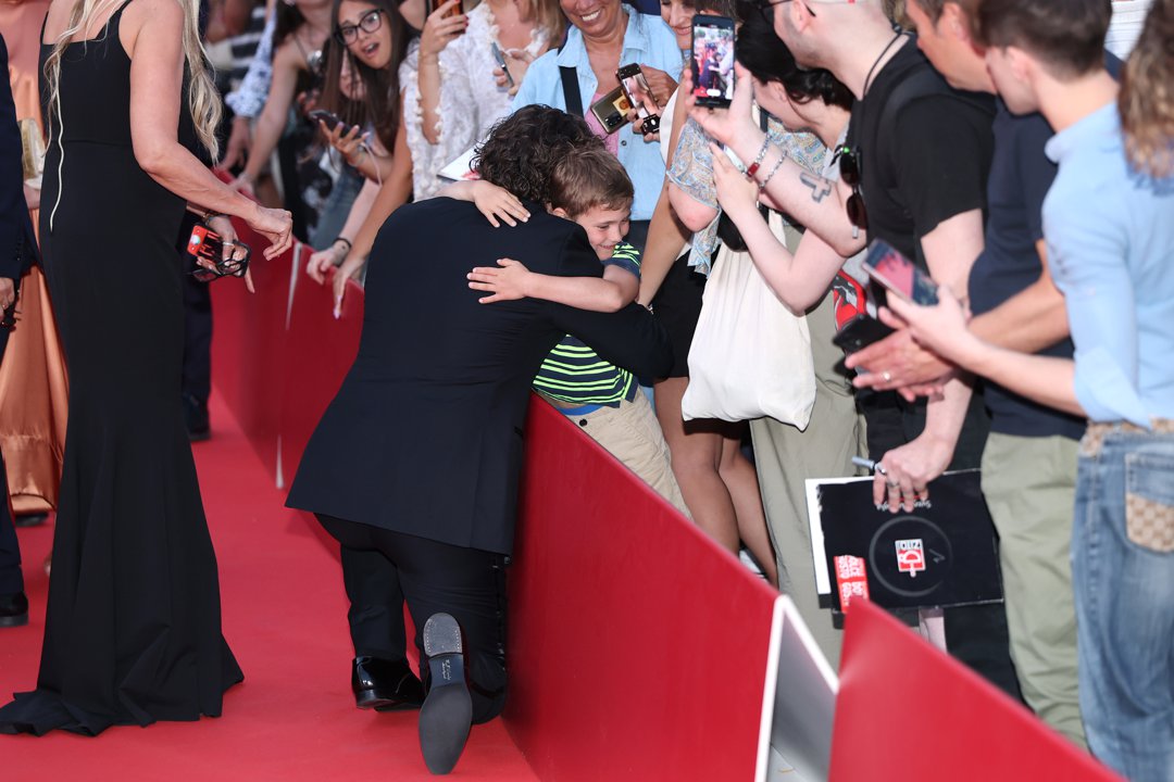 Henry Cavill hugging a young fan during the 71st Taormina Film Festival on June 11, 2025, in Italy. | Source: Getty Images