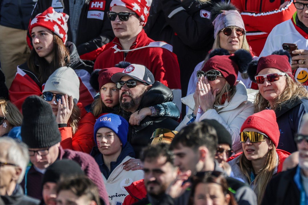 Concerned fans watch replays of Lindsay Vonn's crash during the Women's downhill Alpine skiing event at the Milano Cortina Winter Olympic Games. | Source: Getty Images