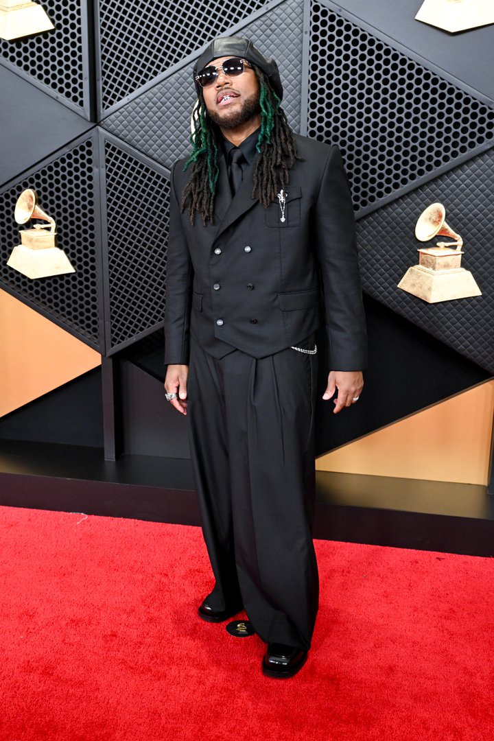 Leon Thomas III stands relaxed and looks toward photographers during arrivals | Source: Getty Images