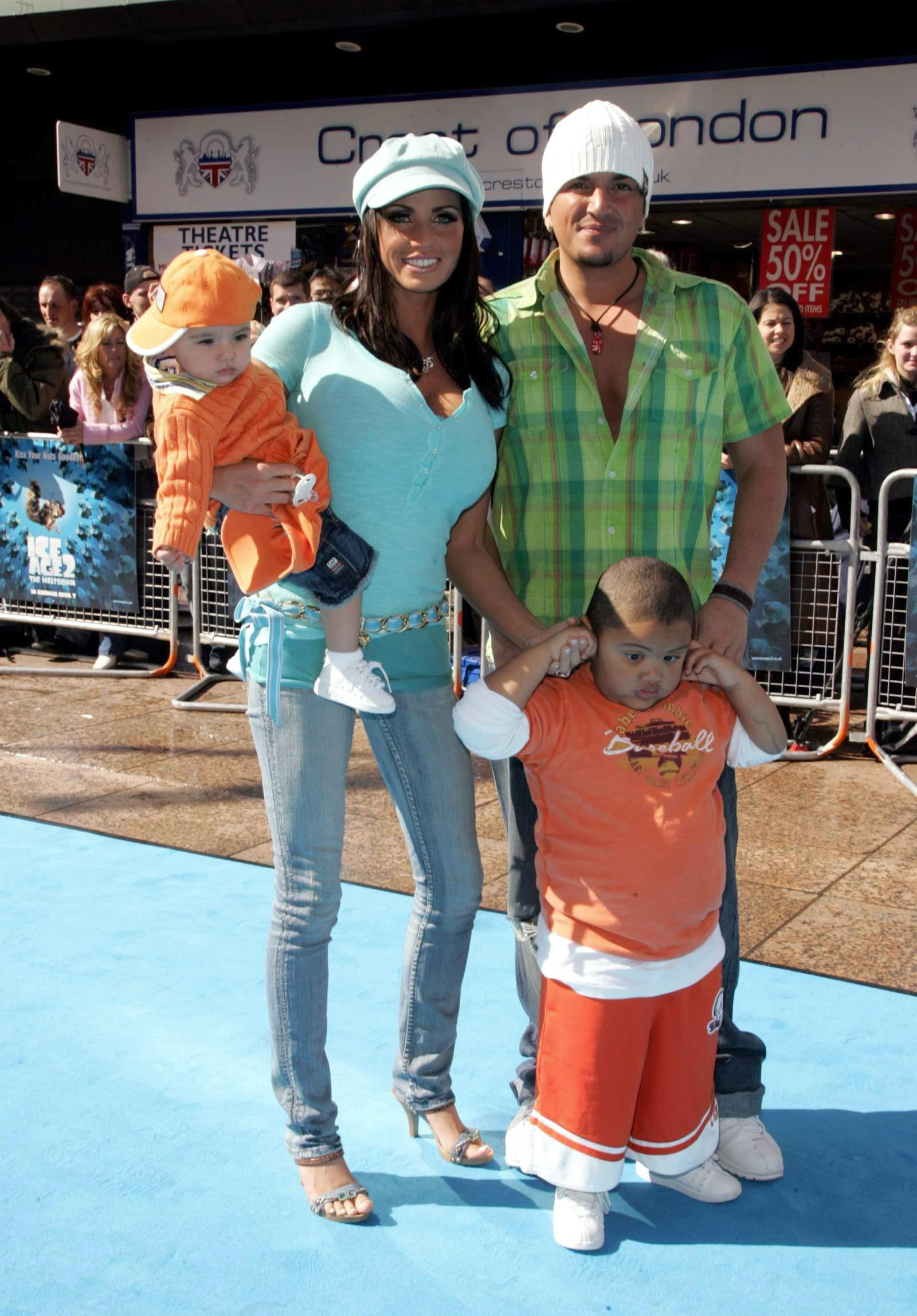 Katie Price and Peter Andre pose on the blue carpet with their children, Harvey Price and Junior Andre, at the London premiere of 
