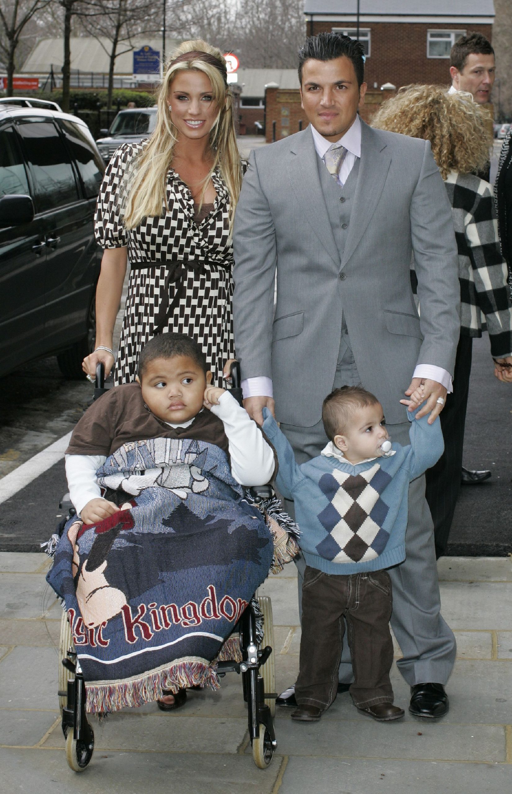 Katie Price and Peter Andre attend the opening of a new Children's Eye Centre at Moorfields Eye Hospital in London on February 23, 2007, accompanied by their sons, Harvey Price and Junior Andre. Wrapped in a 