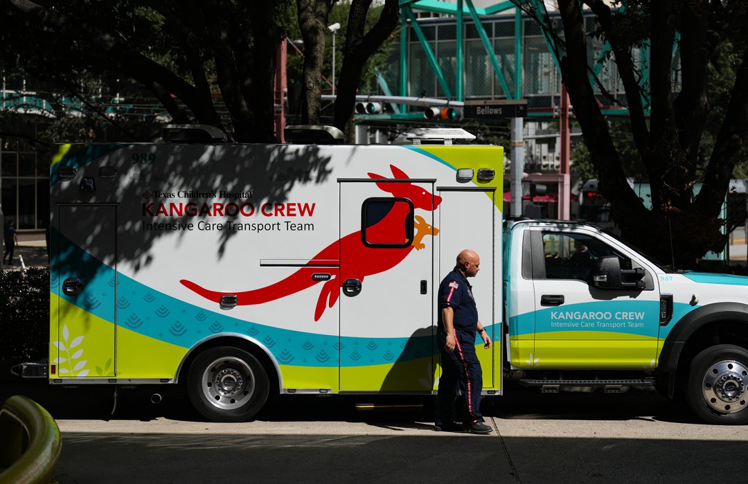 An EMT walking by The Texas Children's Hospital's Kangaroo Crew ambulance in the dock of the hospital in Texas, United States, on September 23, 2025. | Source: Getty Images