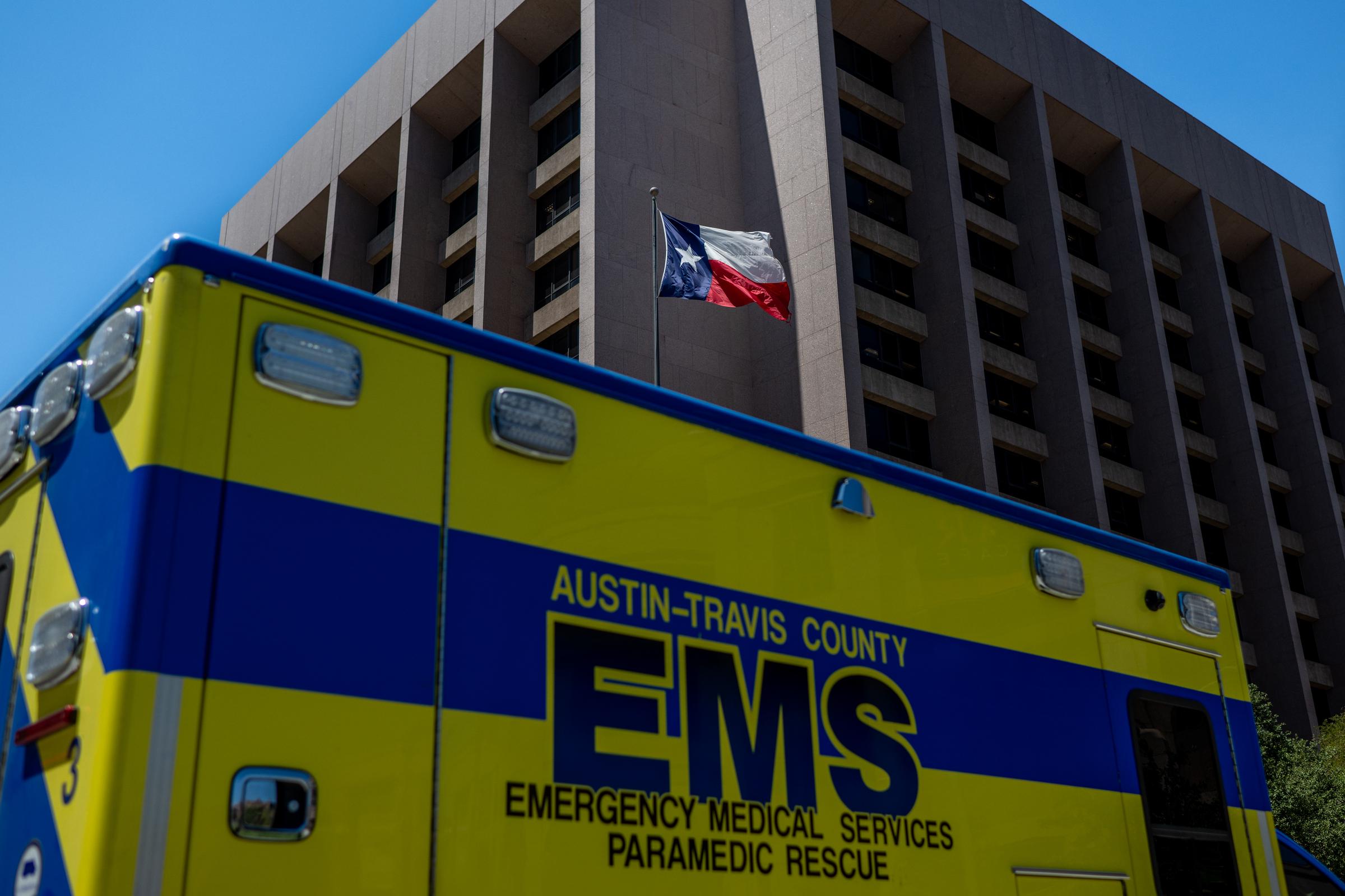 The Texas State flag blowing near an EMS ambulance on August 8, 2023, in Texas, United States. | Source: Getty Images