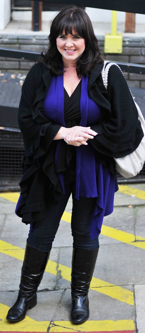 Nolan was all smiles leaving the ITV studios in London on 20 October 2010. Embracing effortless autumn style, she layered a flowing black wrap over a purple tunic, paired with black leggings and knee-high boots. A studded ivory bag, her signature bangs and rosy make-up added a polished touch.