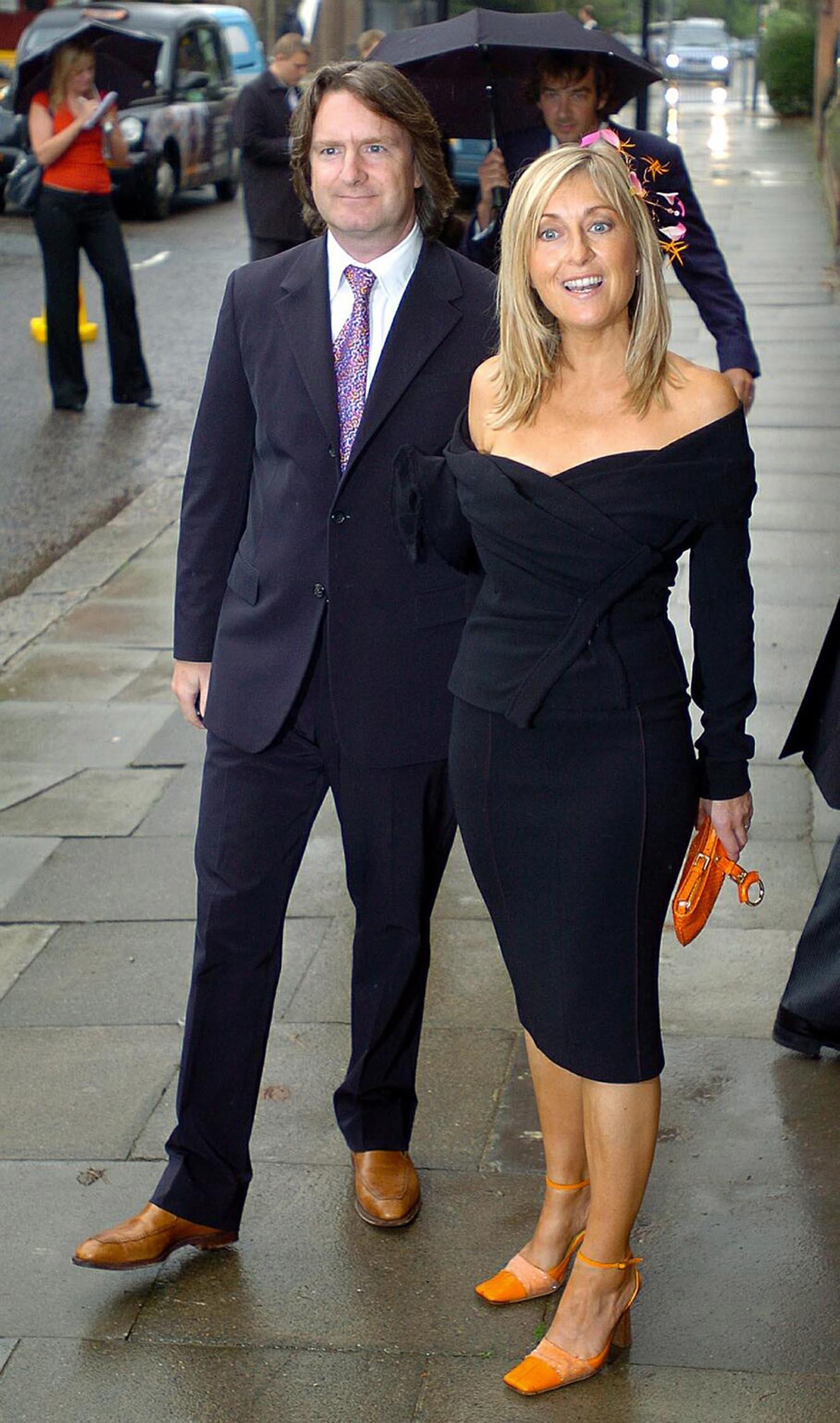 Fiona Phillips with husband Martin Frizell for Kate Garraway's wedding to Derek Draper at St Mary's-the Virgin on 10 September 2005 in Primrose Hill , North London. | Source: Getty Images
