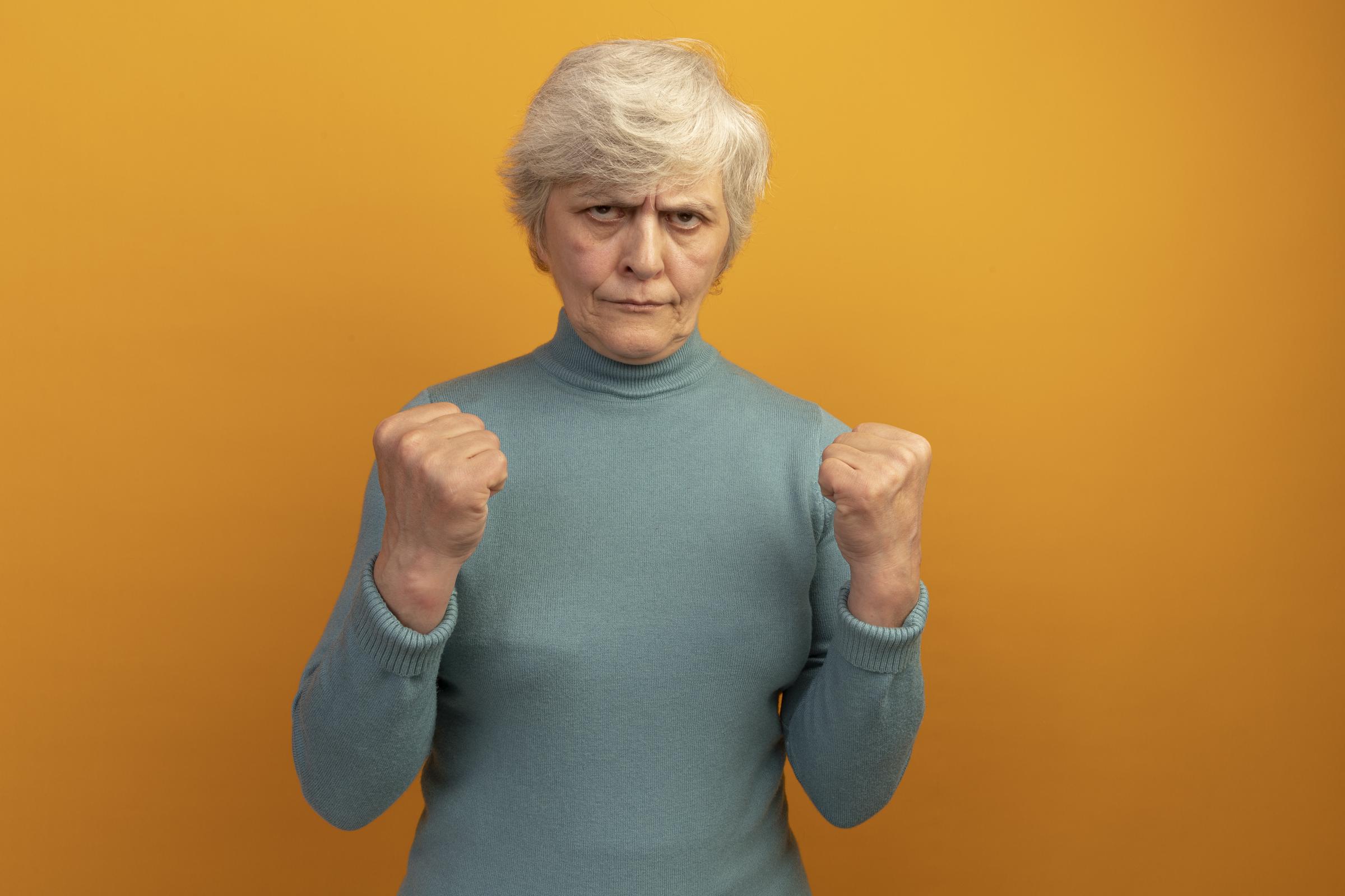 An angry woman with her fists balled up | Source: Freepik