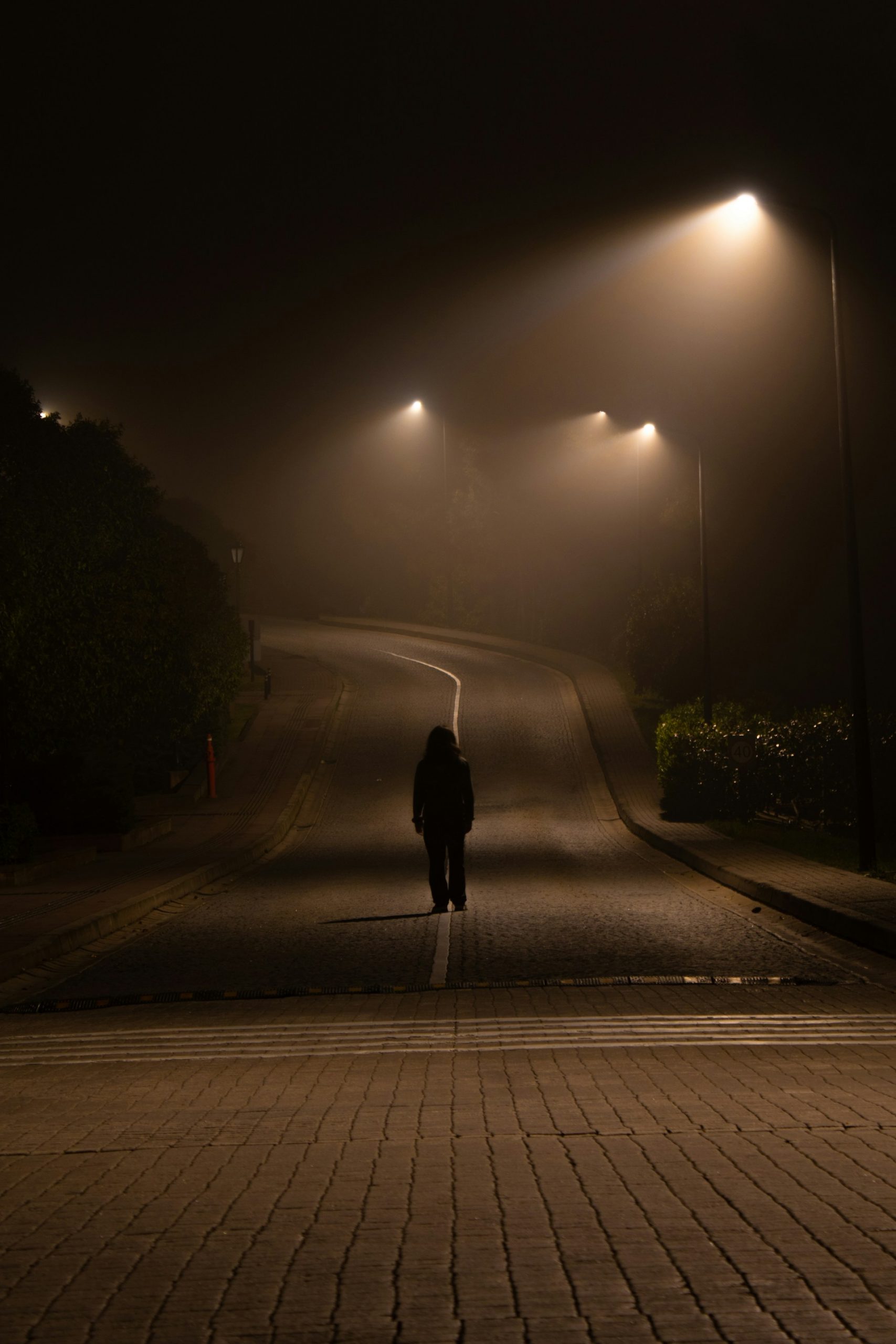 A man on the road at night | Source: Unsplash