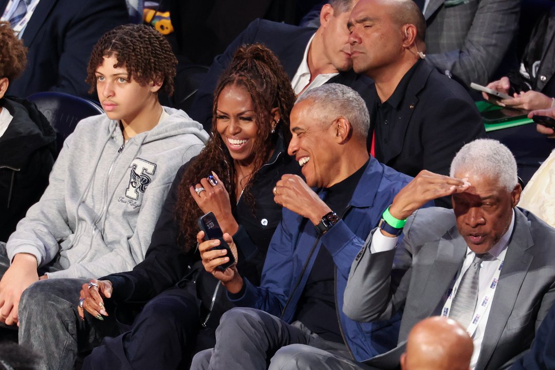 Michelle and Barack Obama sharing a laugh at the 2026 NBA All-Star Game. | Source: Getty Images