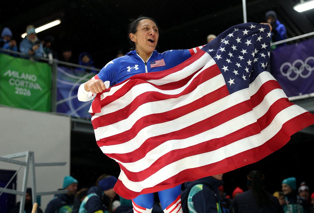 Elana Meyers Taylor celebrates with the American flag after winning gold in the women's monobob at the Winter Olympics in Italy on February 16, 2026 | Source: Getty Images
