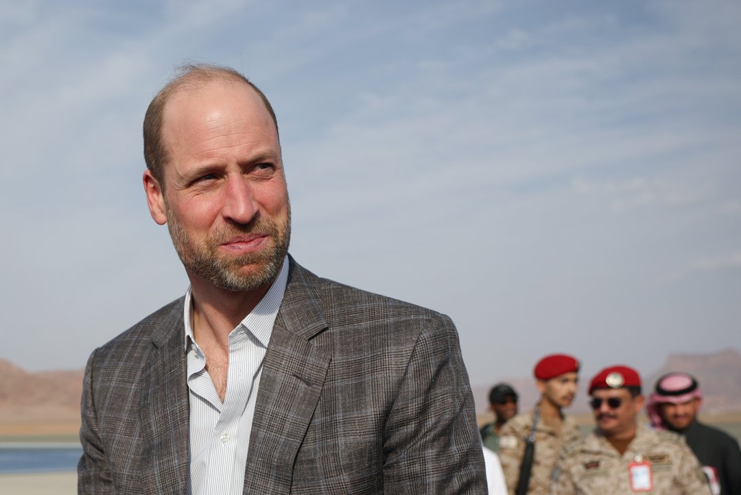 Prince William, Prince of Wales, looks on before boarding a Royal Air Force plane to depart from AlUla Airport as he leaves Saudi Arabia on the last day of his first official trip to the country on February 11, 2026. | Source: Getty Images