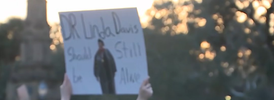 During the protest outside Forsyth Park, the sign can be read, from a post dated  February 18, 2026. | Source: YouTube/WJCLNews