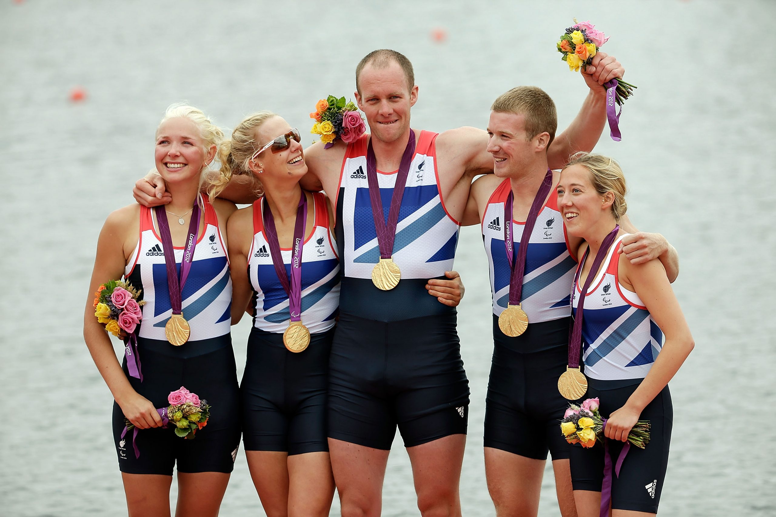 Triumph and Tears: In a defining moment of glory, Smith stands centre stage at Eton Dorney on 2 September 2012, beaming with pride. Clutching a bouquet and with his Paralympic gold medal gleaming, he celebrates an emotional victory with his Mixed Coxed Four crew on day four of the Games.