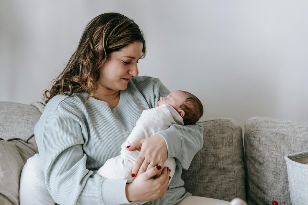 Mom holding her newborn | Source: Pexels