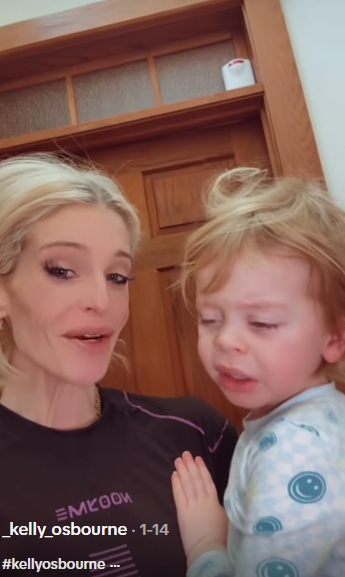 Moments later in the same January 14, 2026, video, Osbourne's expression shifts as she appears to gently speak to her son, who looks downward with heavy eyelids and tousled hair. His small hand rests against her chest, reinforcing the closeness of the embrace. The candid still conveys a quieter, more vulnerable exchange. | Source: TikTok/_kelly_osbourne