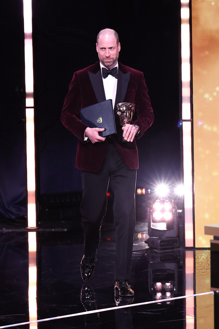 Under bright stage lights at the Royal Festival Hall, the Prince of Wales stepped forward to present the BAFTA Fellowship during the film awards, holding the iconic bronze mask. Dressed in his maroon velvet blazer and black tie, he cut a composed figure as he fulfilled his role as President of the BAFTAs on February 22 in London, England.