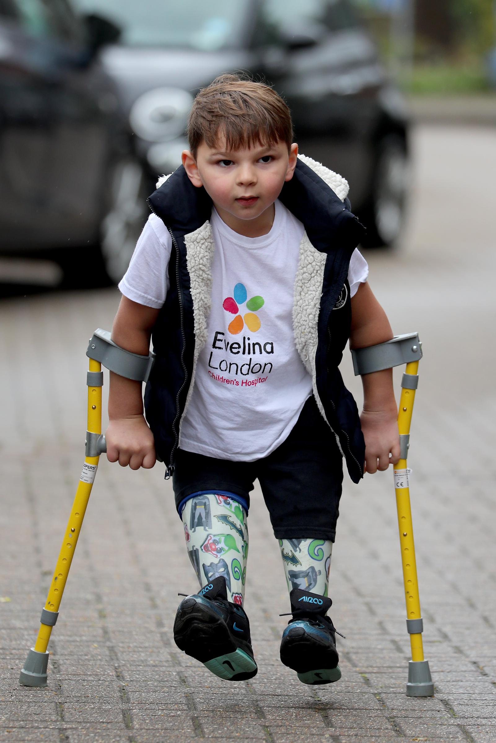 A determined five-year-old Tony Hudgell, wearing an Evelina London Children's Hospital t-shirt and supported by yellow forearm crutches, takes his final steps of his fundraising walk in West Malling, Kent, on 30 June 2020. Tony walked 10 kilometres throughout June, raising over &pound;1 million for the hospital that had cared for him since he was four months old.