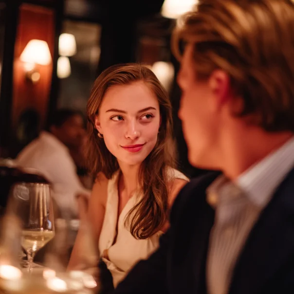 A woman looking at her boyfriend sweetly while on a date | Source: Midjourney