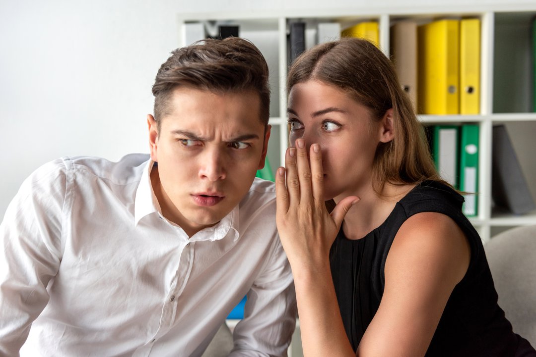 Woman in office doing gossip | Source: Getty Images