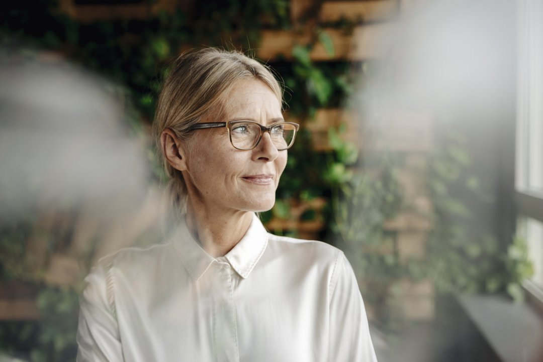 Businesswoman in green office looking out of window | Source: Getty Images